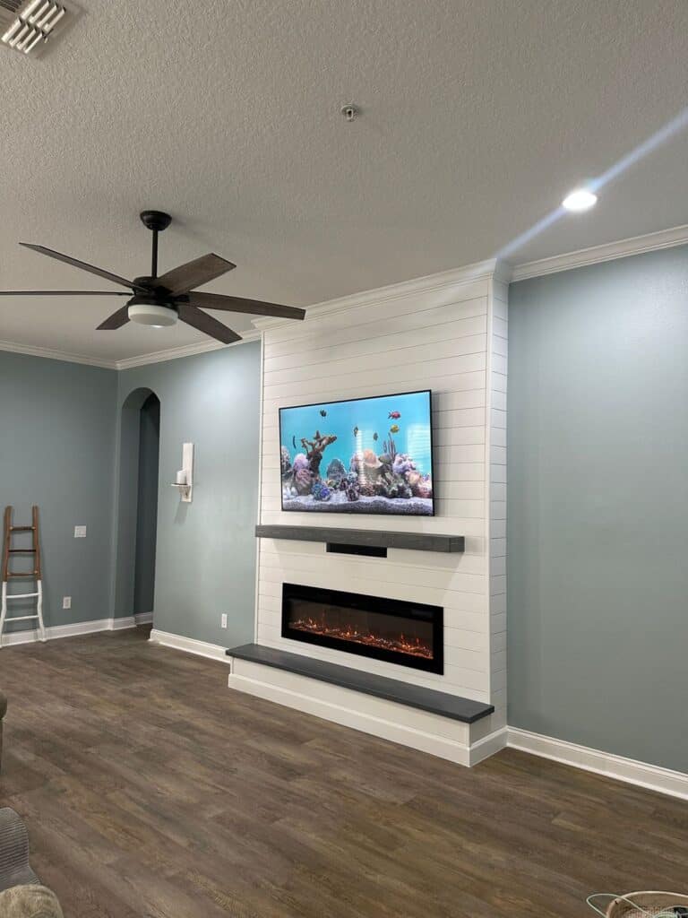 White shiplap TV wall with linear electric fireplace