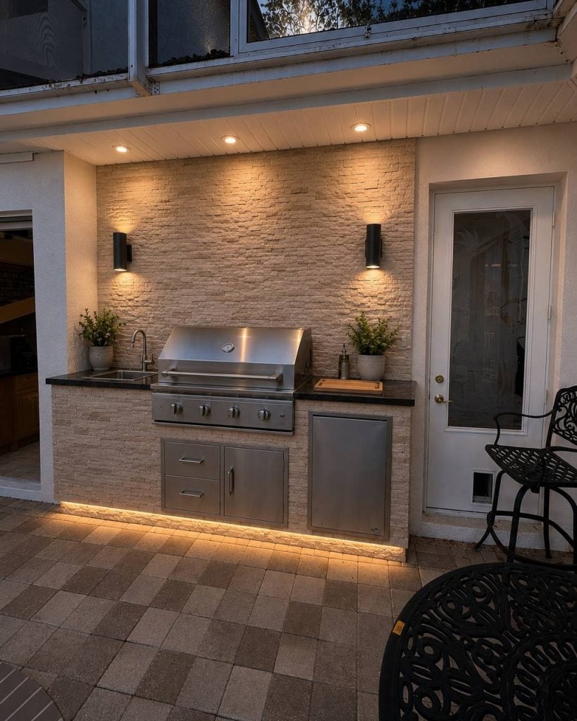 Outdoor kitchen with stacked stone wall and under-counter LED lighting