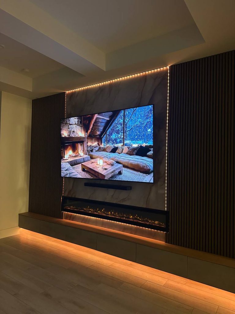 Dark media wall with warm LED accent lighting at night