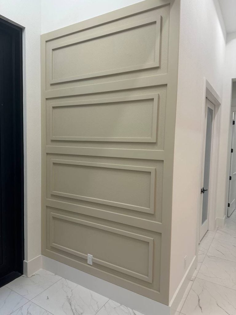 Greige picture-frame molding wall by the entry