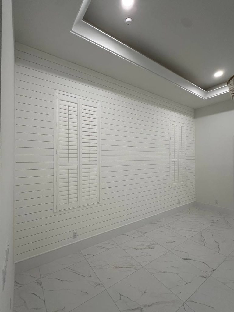 White brick-style accent wall in a bedroom