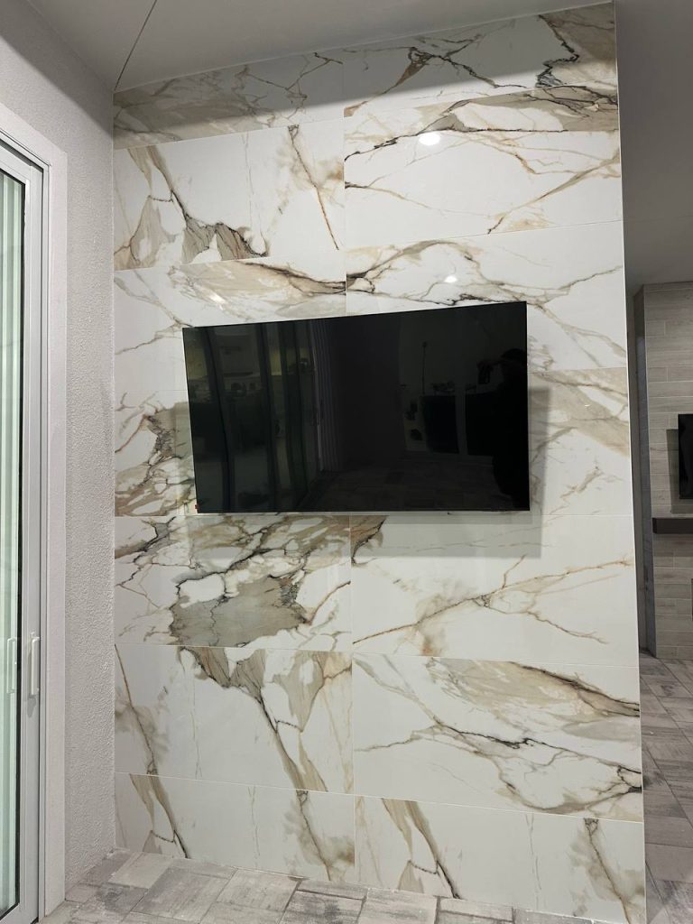 Book-matched marble feature wall with recessed TV