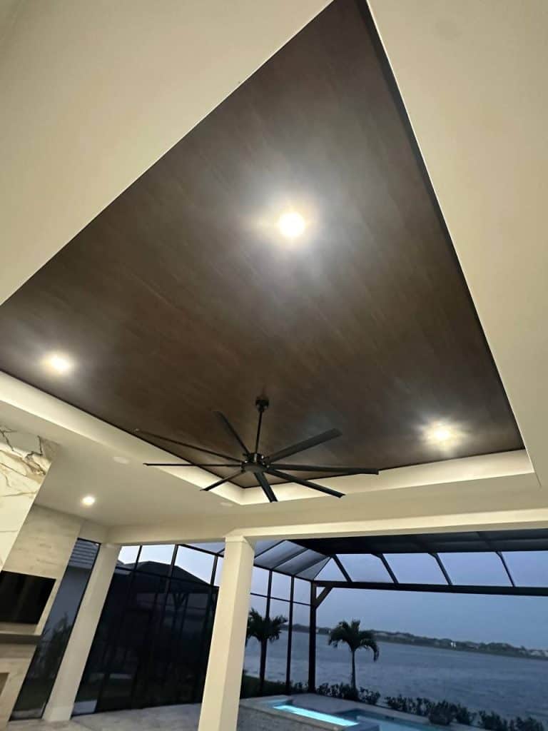 Covered lakeside patio with stained wood ceiling