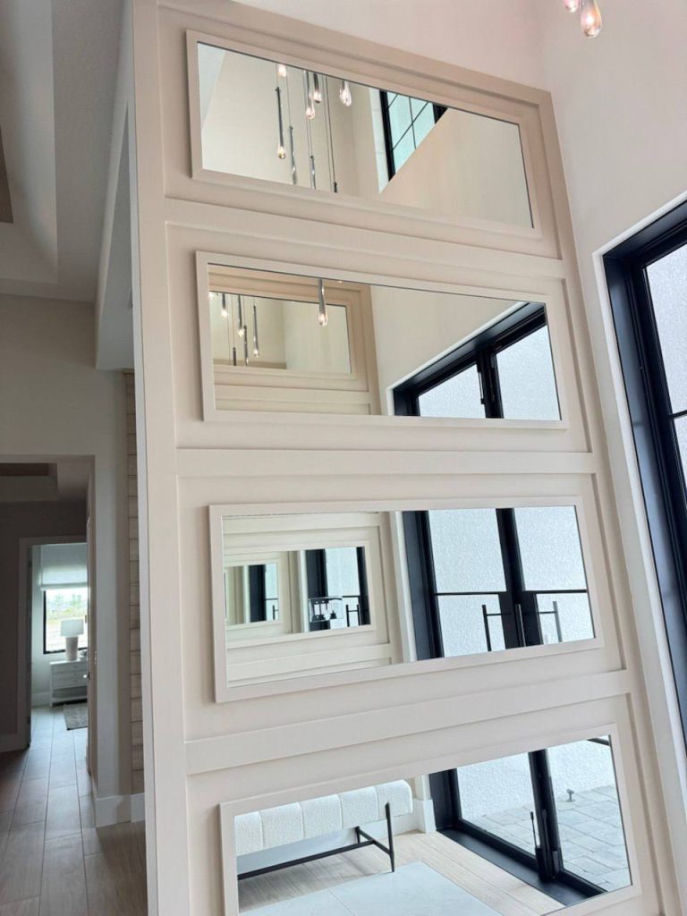 Two-story mirrored panel feature wall