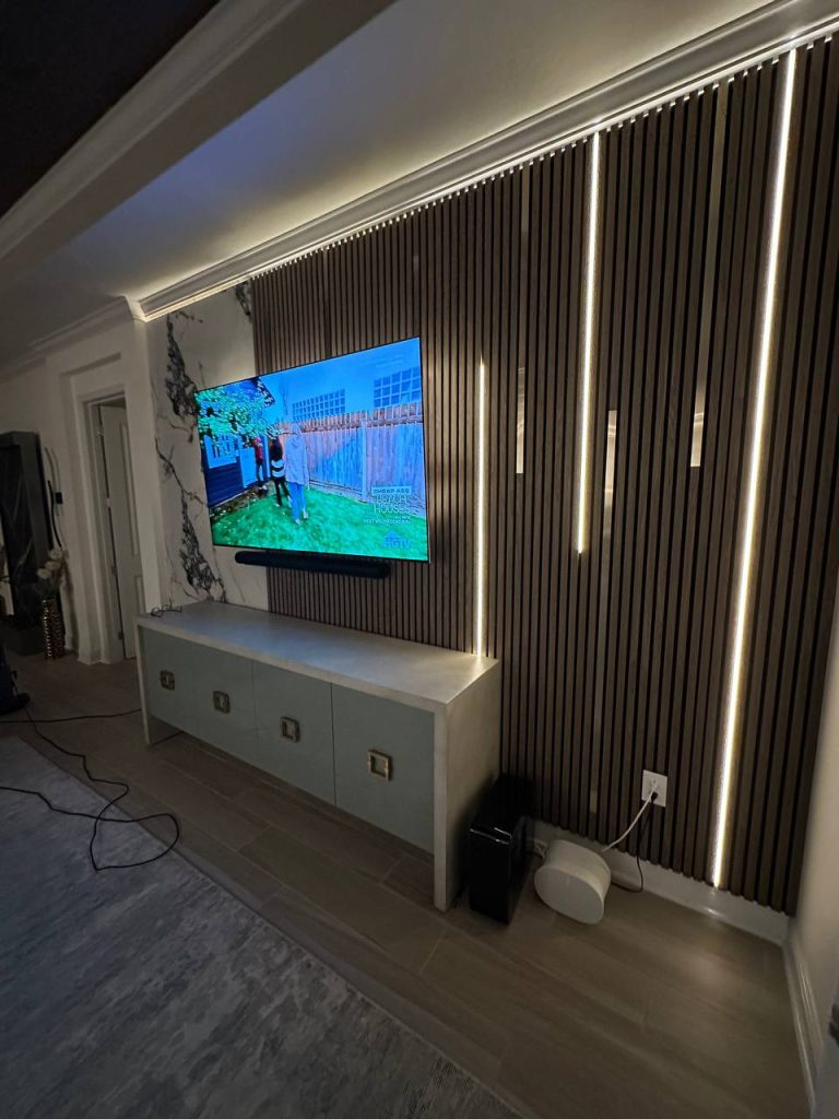 Slat and marble feature wall with vertical LED at night