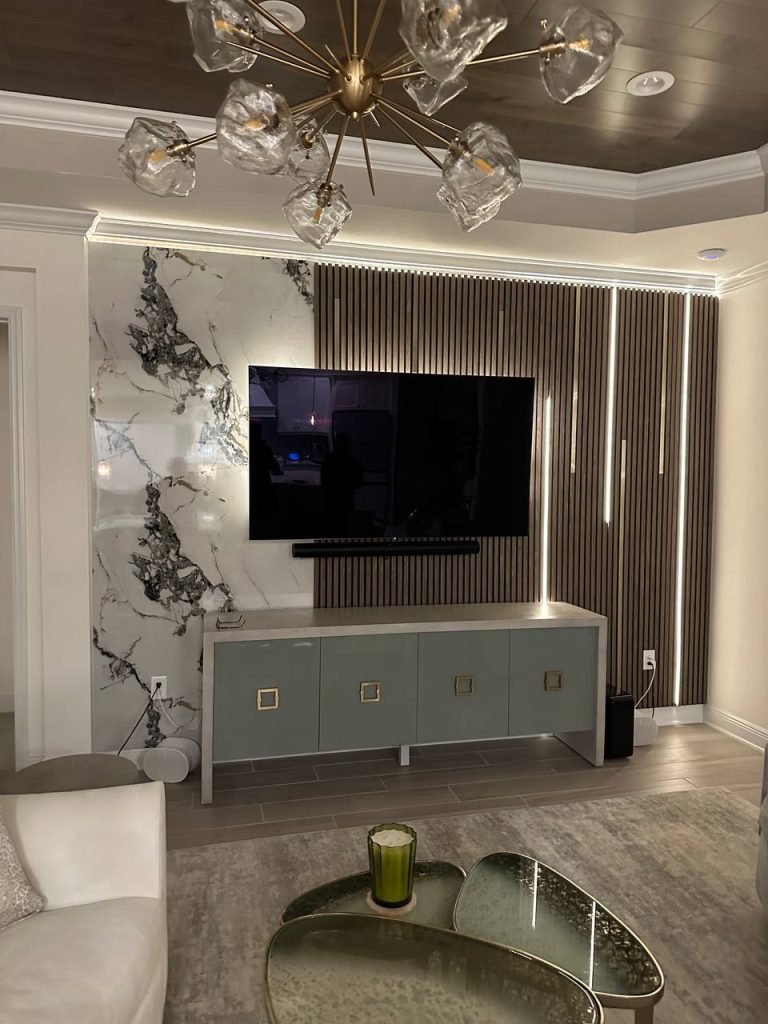 Slat feature wall with book-matched marble panel and designer lighting