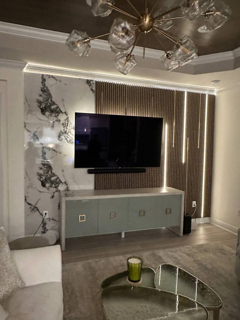 Slat and marble media wall with designer ice chandelier